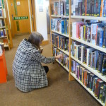 A library borrower choosing books